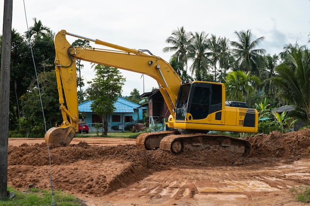 Yellow excavator on a construction site against blue sky Heavy industry