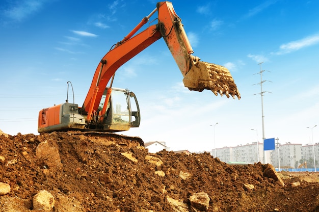 Yellow excavator on the site