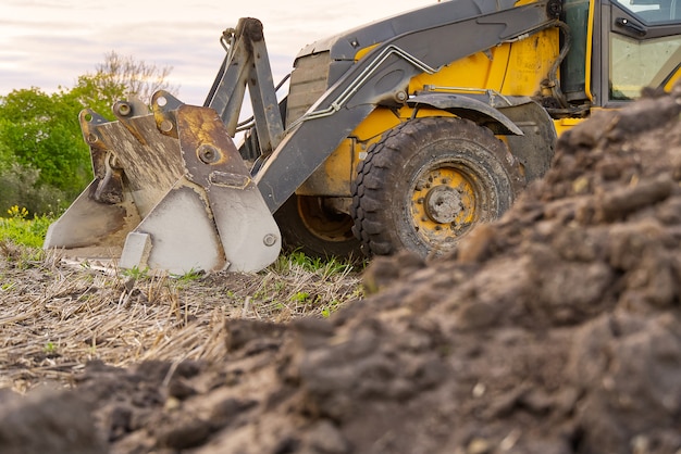 Yellow Excavator. yellow tractor on the field.