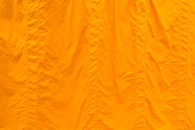 Yellow fabric texture background, clergy robe in buddhism