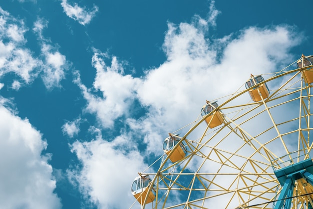 Yellow Ferris wheel under the blue sky