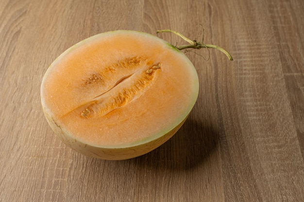 Melone a polpa gialla tagliato a metà è un frutto che contiene vitamina c, vitamina a, beta-carotene, calcio, fosforo e ferro.