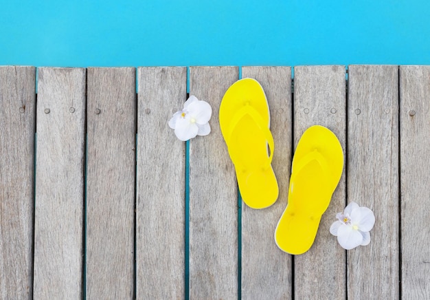 Photo yellow flip flops by the pool