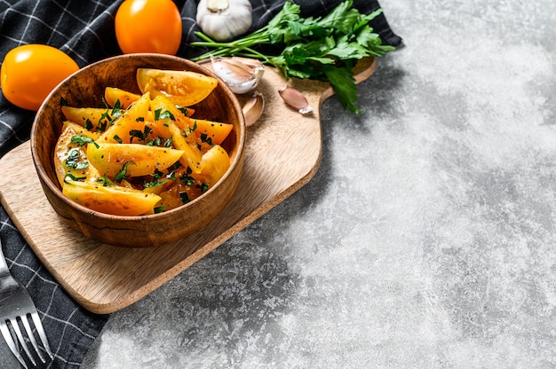 Yellow fresh tomato salad with capers, olive oil and parsley