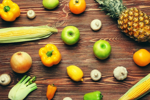 Yellow fruits and vegetables on wooden background