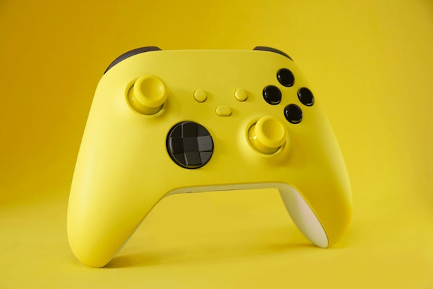 Yellow game controller on Yellow background