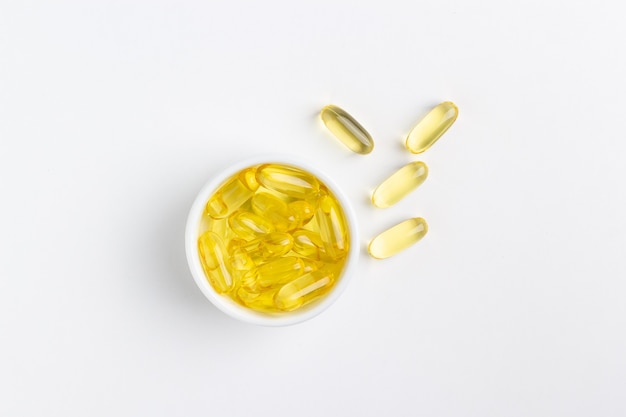 yellow gel fish oil pills on white background