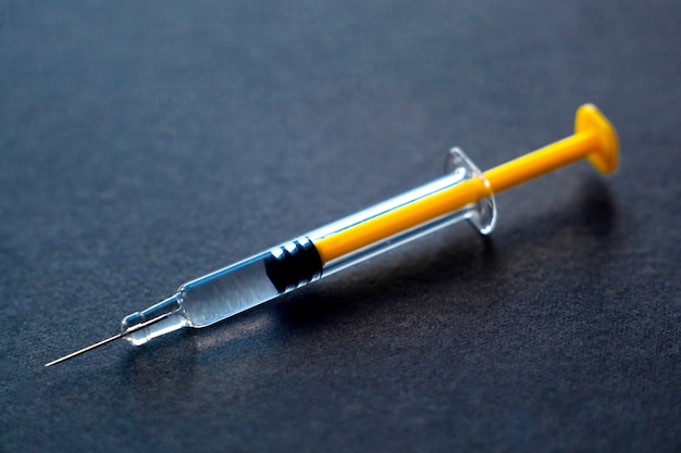 Yellow glass medical syringe