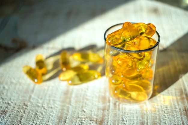 Yellow gold oil vitamin, omega 3 capsules