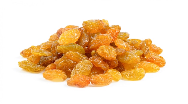 Yellow golden raisins on white wall