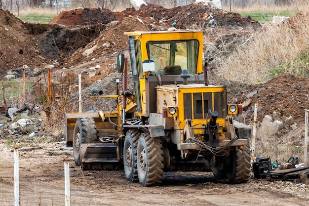 Yellow grader in a landfill