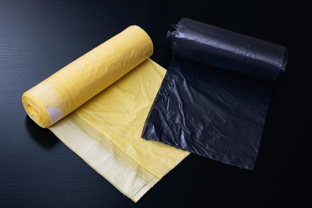 Yellow and gray garbage bags on wooden table