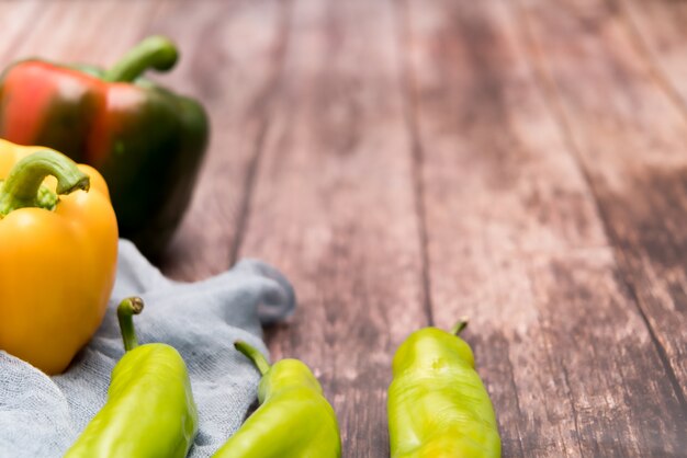 Yellow and green bell pepper on the wooden backgrounds