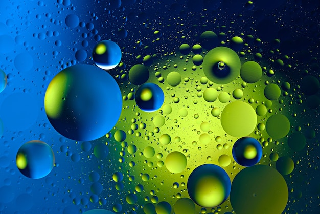 Yellow green neon bubbles on colorful background, art texture