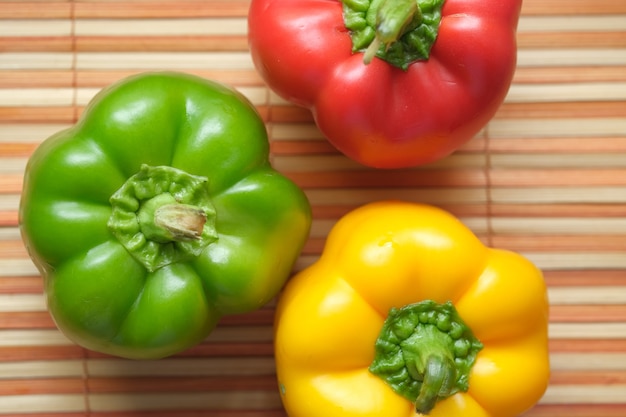 Yellow green and red capsicum on table top view