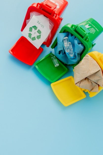 Yellow, green and red recycle bins with recycle symbol on blue. Keep city tidy, Leaves the recycling symbol