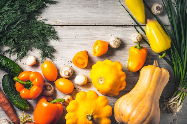 Yellow and green vegetables on the white wooden table horizontal