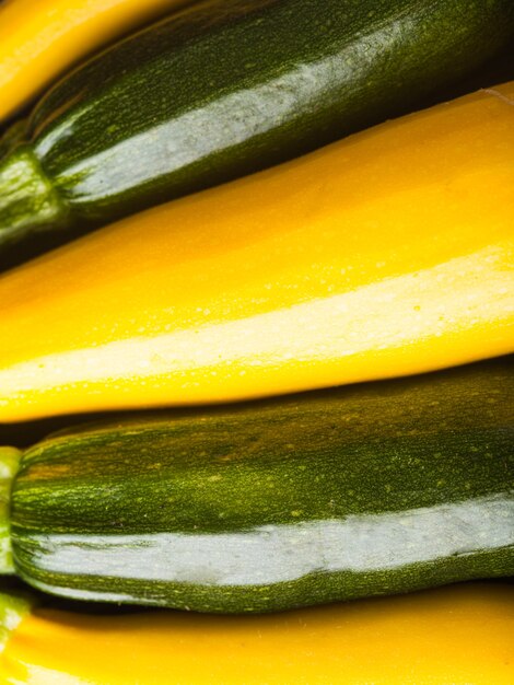 Yellow and green zucchini on the as a background