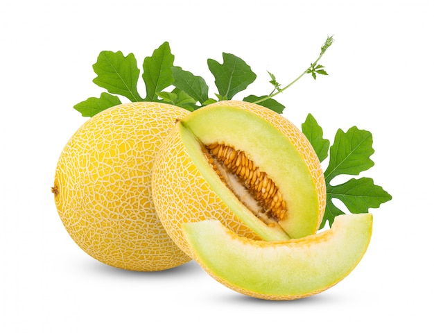 Yellow half cantaloupe melon with leaves on white table. 