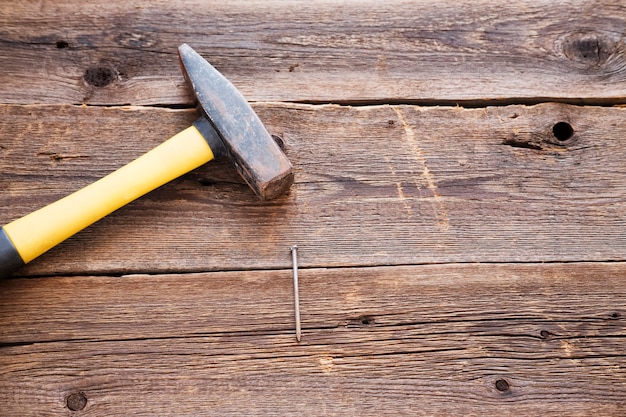 yellow hammer on a natural wooden background