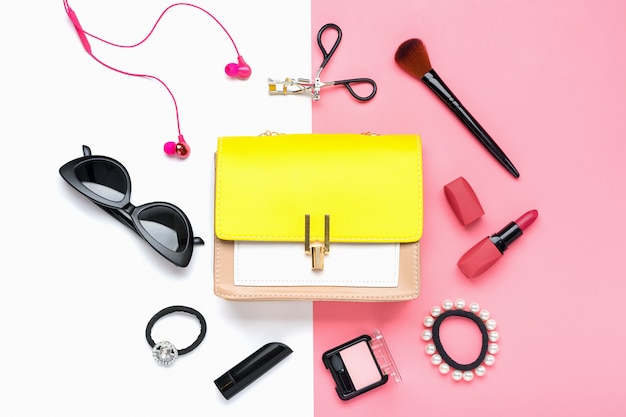 Yellow handbag with woman's accessories