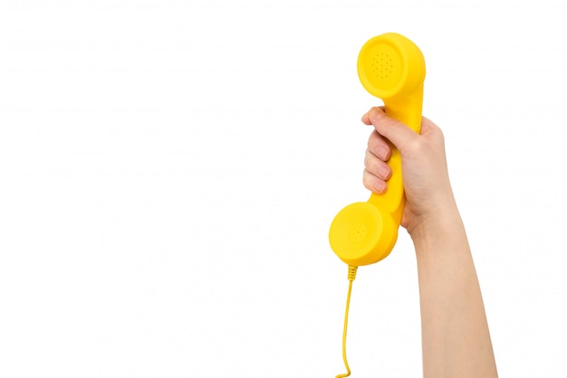 Yellow handset in woman's hand isolated