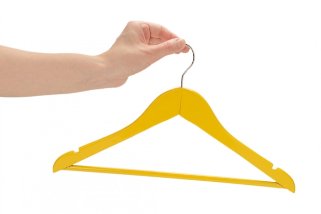 Yellow hanger in woman hand isolated on white.