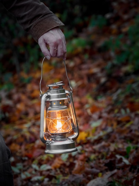 Yellow hanging lantern in hand at night. Close up.