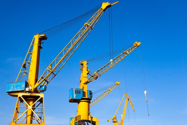 Yellow harbor cranes against the blue sky