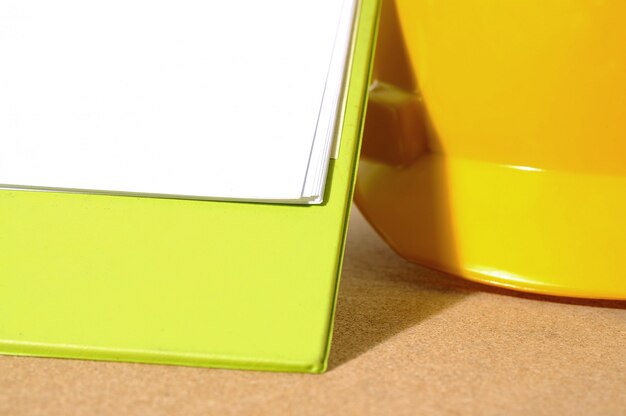 Yellow hard hat and clipboard. You can put your design on the clipboard