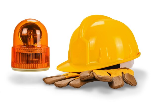 Photo yellow hard hat and leather work gloves