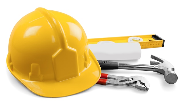 Photo yellow hard hat and tools on background