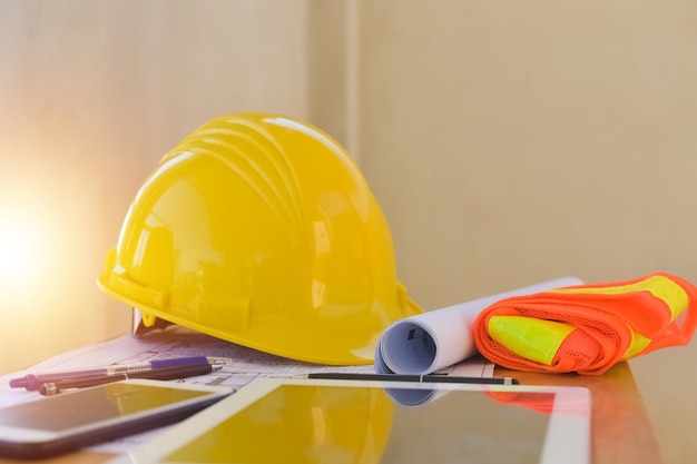 Yellow helmet hard hat safety for safety work and equipment on\
desk office engineering engineer safety in work