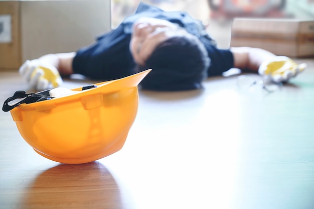 Yellow helmet of injured lying worker at work.