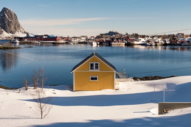 Yellow house on snow in fishing village