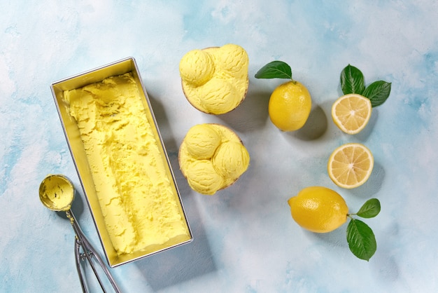 Yellow ice cream  out of container, top view.  Ice cream balls.