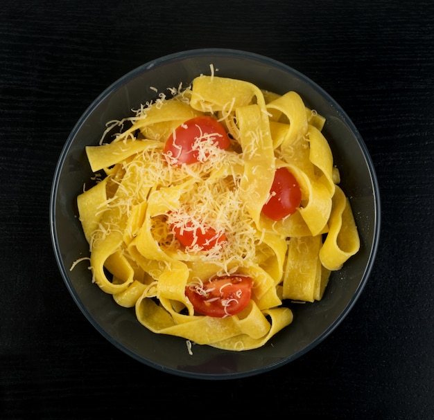 Yellow italian pappardelle with tomato