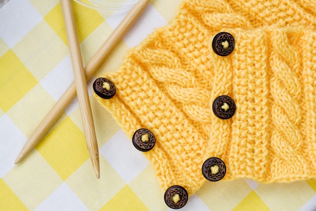 Yellow knitted pattern on a fabric background