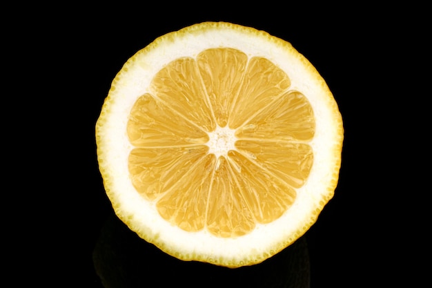 Yellow lemon closeup cut black surface