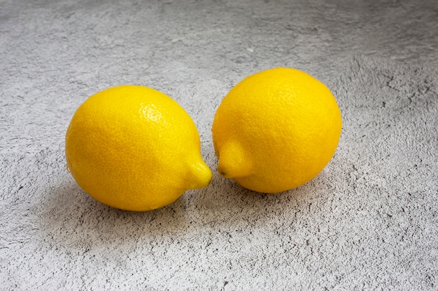 Yellow lemon on a gray table.