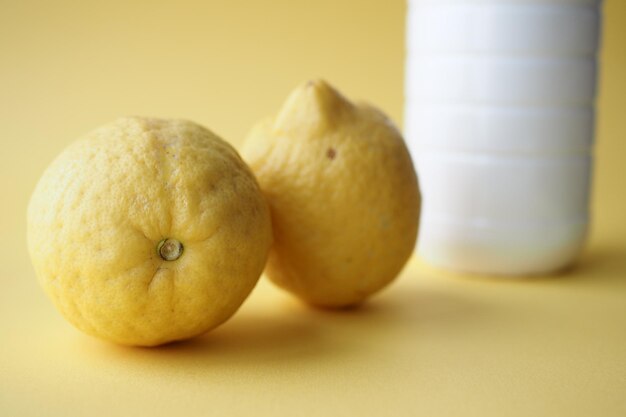 Yellow Lemon and milk jar on table