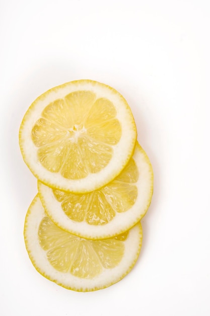 Yellow lemon slices on white background