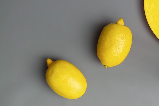 Yellow lemons on gray background