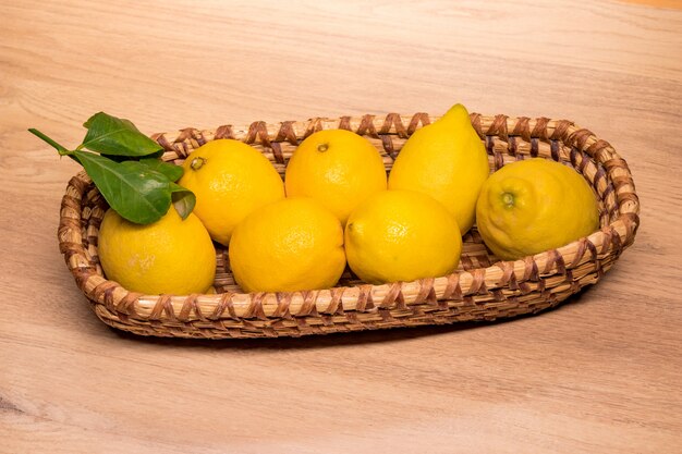 Yellow lemons in a small wooden basket