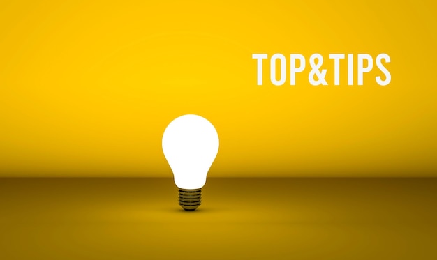 A yellow light bulb with the word top & tricks on it