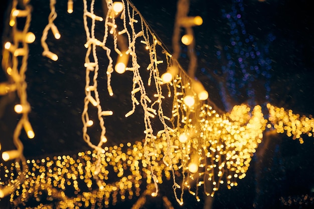 Yellow lights bokeh from christmas holiday garlands blurred festive background abstract lights