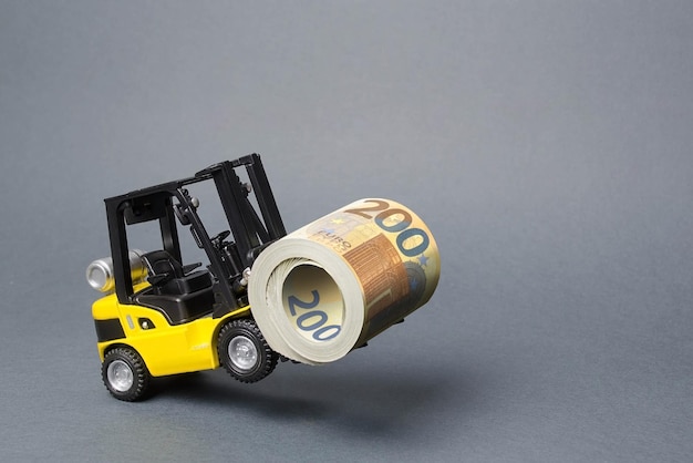 A yellow loader stands on the rear wheels holding a big roll bundle of Euro attracting investment