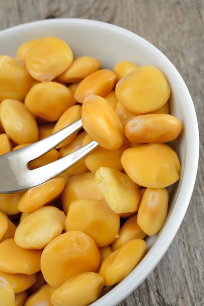 Yellow lupins in white bowl