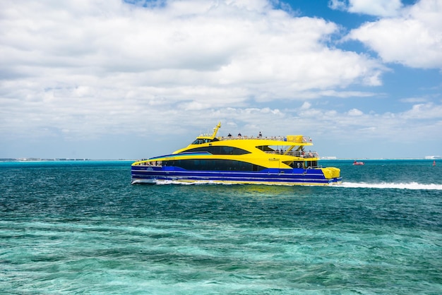 Yellow luxury yacht in bay on the azure turquoise seashore in caribbean sea Isla Mujeres Cancun Yucatan Mexico