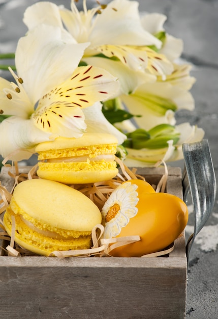 Yellow macaroons with heart in box